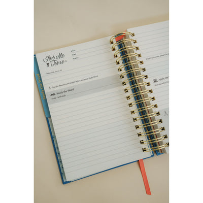 Inside pages of the Give Me Jesus Journal showing the daily Bible study layout and lined sections.