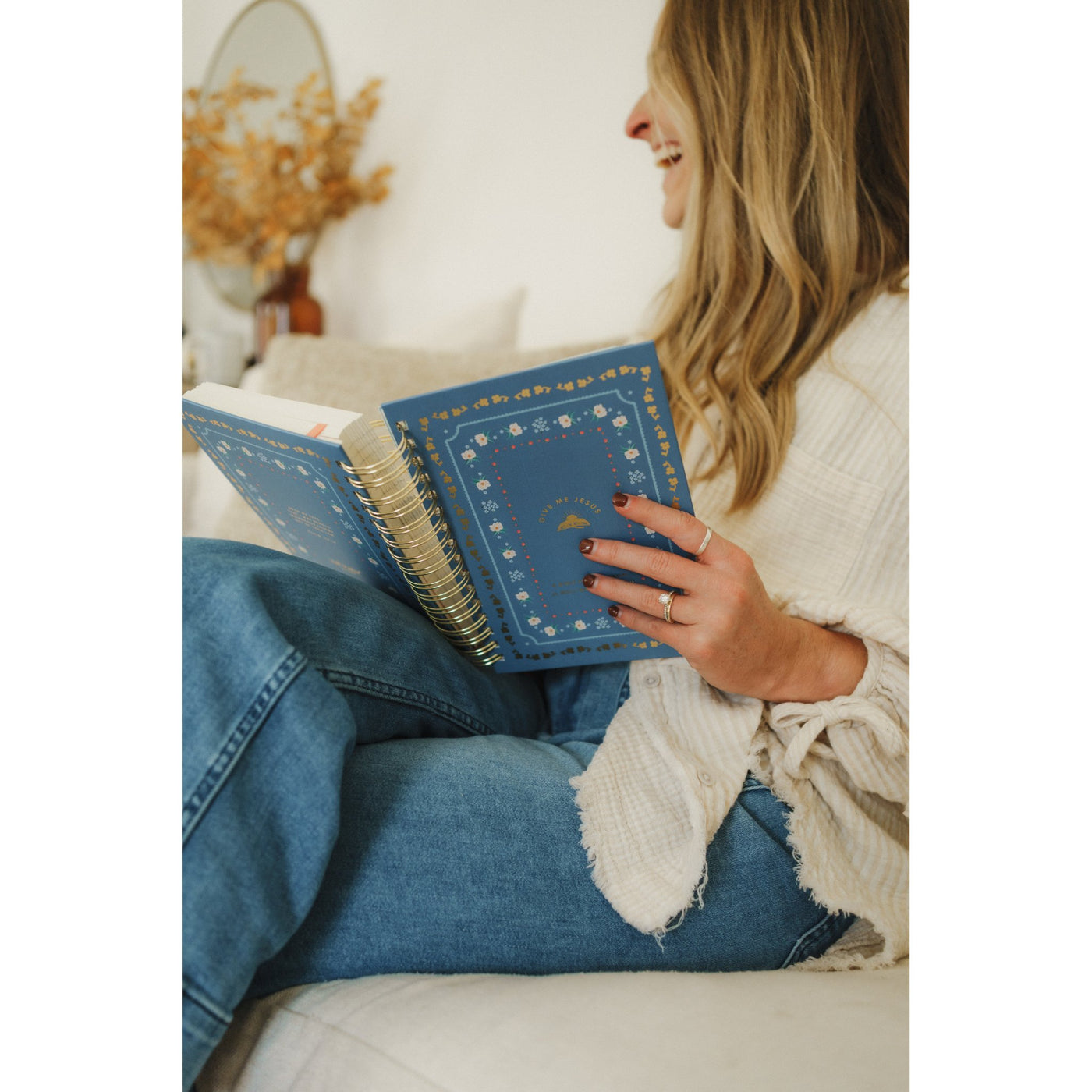 Woman sitting comfortably and holding the Give Me Jesus Journal in her lap during quiet time.